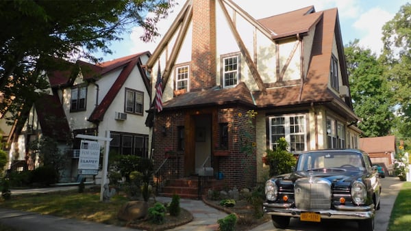 From Paramount Realty USA: "This traditional Tudor-style home in renowned Jamaica Estates features a brick and stucco exterior and an old world charm interior featuring arched doorways, hardwood floors, 5 bedrooms, 4.5 baths, library, living room with fireplace, formal dining room, basement and more."