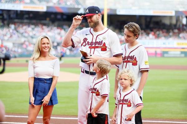 Braves pitcher Chris Sale celebrates with his family after receiving the team's Roberto Clemente award before a game in September.