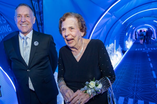 Delta Air Lines celebrates its 100-year anniversary on Saturday, March 15, 2025 at the Delta Flight Museum. Babs Gordon, right, a flight attendant hired in 1955, recounts here first days with the company and is with her neighbor, Thom Canning-Skinner, left, also a Delta flight attendant. (Jenni Girtman for The Atlanta Journal-Constitution)