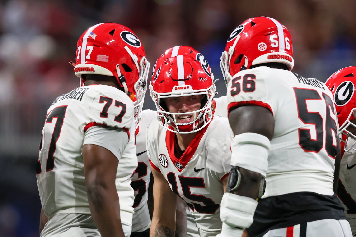 Georgia Bulldogs quarterback Carson Beck (15) huddles against the Alabama Crimson Tide during the second half of the SEC Championship football game at the Mercedes-Benz Stadium in Atlanta, on Saturday, December 2, 2023. (Jason Getz / Jason.Getz@ajc.com)