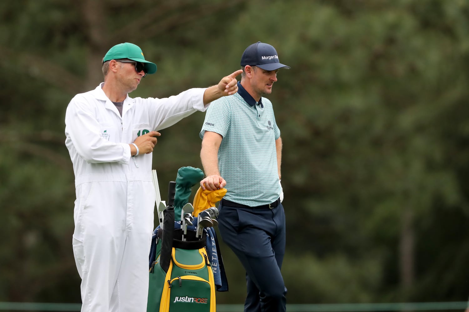 April 9, 2021, Augusta: Justin Rose and his caddie David Clark discuss RoseÕs next shot on the fifteenth fairway during the second round of the Masters at Augusta National Golf Club on Friday, April 9, 2021, in Augusta. Curtis Compton/ccompton@ajc.com