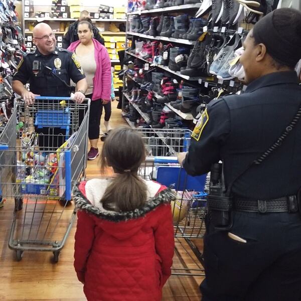 Gwinnett County officers shop with children at a recent holiday event. (Photo: Lawrenceville Police)