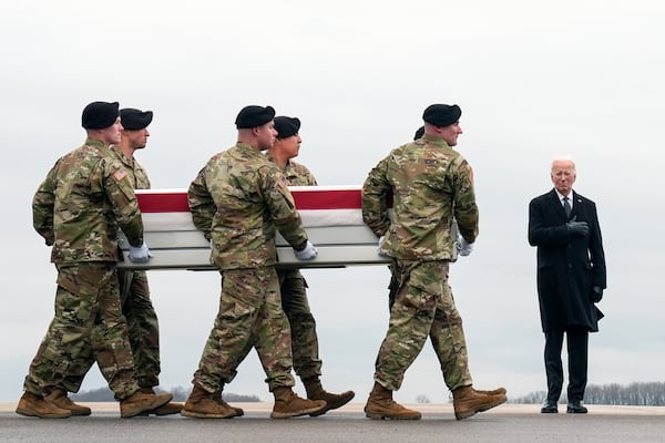 FILE - President Joe Biden, right, stands as an Army carry team moves the transfer case containing the remains of U.S. Army Sgt. Kennedy Ladon Sanders, 24, of Waycross, Ga., at Dover Air Force Base, Del., Friday, Feb. 2, 2024, after Sanders was killed in a drone attack in Jordan on Jan. 28. (AP Photo/Matt Rourke, File)