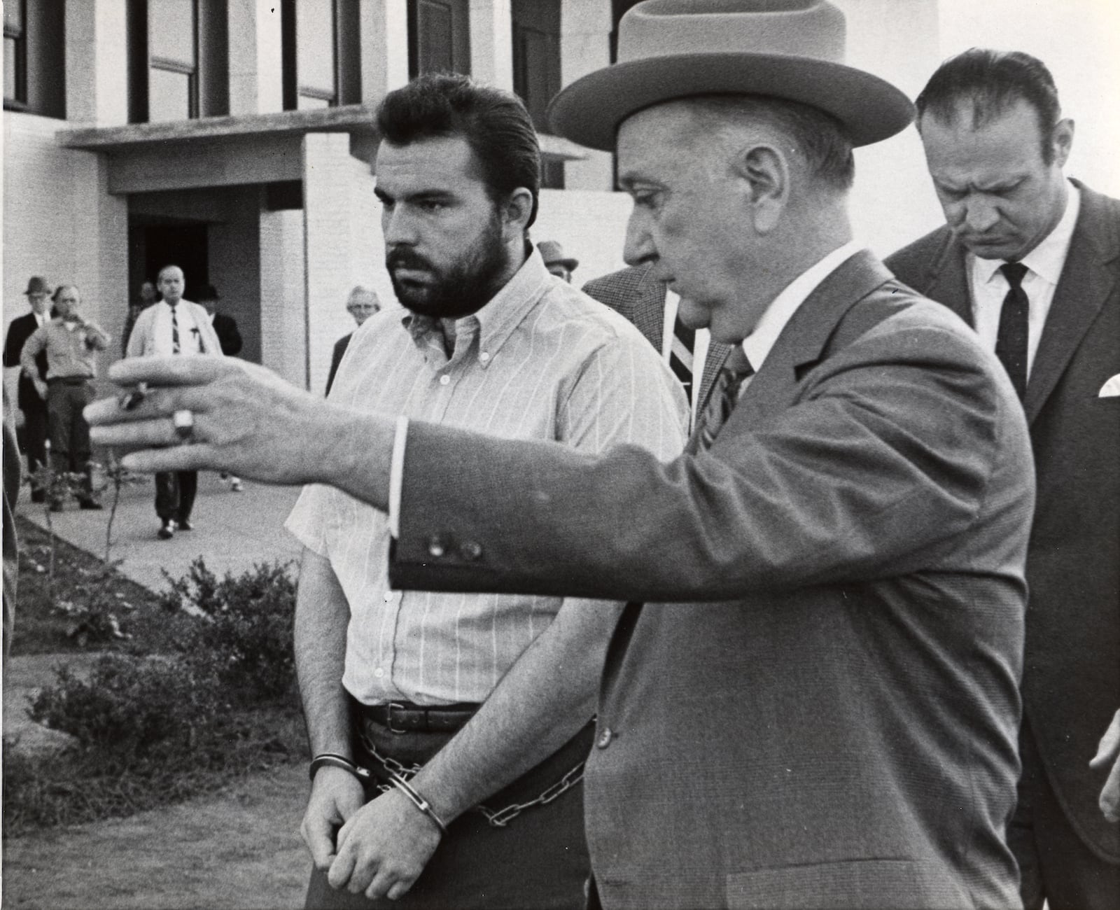 Feb. 7, 1969 - Gary Steve Krist, left, is shown the way back to his jail cell an officer after two court-appointed attorneys were granted a three week continuation in DeKalb County Superior Court at Decatur, Ga. in the arraignment of Krist on charges of abducting Barbara Jane Mackie, 20,, of Miami, Fla. Source: File/AP