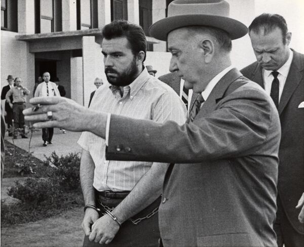 Feb. 7, 1969 - Gary Steve Krist, left, is shown the way back to his jail cell an officer after two court-appointed attorneys were granted a three week continuation in DeKalb County Superior Court at Decatur, Ga. in the arraignment of Krist on charges of abducting Barbara Jane Mackie, 20,, of Miami, Fla. Source: File/AP