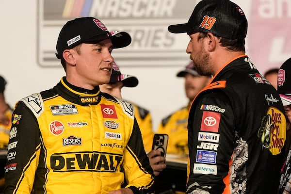 Christopher Bell, left, speaks with Chase Briscoe after bell won the race after a NASCAR Cup Series auto race, Sunday, Feb. 23, 2025, in Hampton, Ga. (AP Photo/Mike Stewart)