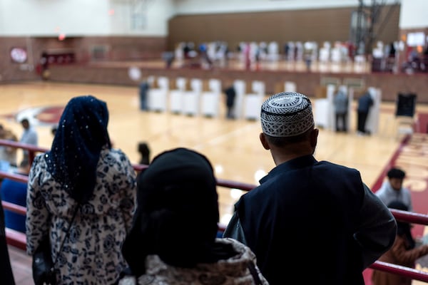 Voters wait in line to cast their ballots at the Hamtramck High School polling site on Election Day, Tuesday, Nov. 5, 2024, in Hamtramck, Mich. (AP Photo/David Goldman)