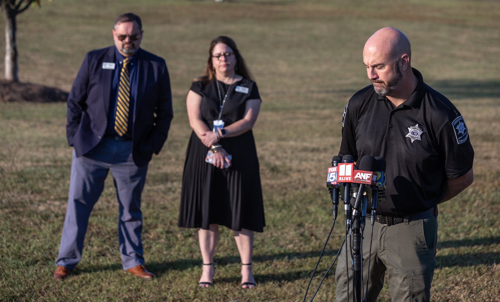 Barrow County sheriff Jud Smith (right) spoke as Barrow County Schools Chief of Staff, Dr. Matt Thompson (left) and Director of Communications and Engagement Nicole Valles (center) look on. Apalachee High School students returned to the Barrow County campus for the first time Monday, Sept. 23, 2024 after police say a 14-year-old student shot and killed four people at the school on Sept. 4. Barrow County Sheriff Jud Smith called the return “a huge step for us healing” in a briefing with reporters ahead of an open house for students. (John Spink/AJC)