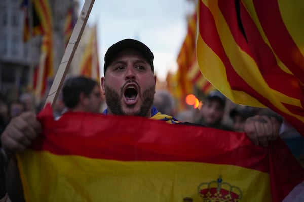 A demonstrator shouts during a protest organized by social and civic groups, denouncing the handling of recent flooding under the slogan "Mazón, Resign," aimed at the president of the regional government Carlos Mazon, in Valencia, Spain, Saturday, Nov. 9, 2024. (AP Photo/Emilio Morenatti)