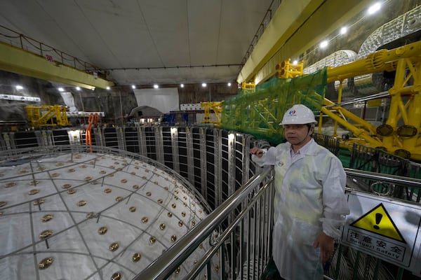 Wang Yifang, chief scientist and project manager at the Jiangmen Underground Neutrino Observatory briefs visitors on the cosmic detector located 2297 feet (700 meters) underground in Kaiping, southern China's Guangdong province on Friday, Oct. 11, 2024. (AP Photo/Ng Han Guan)