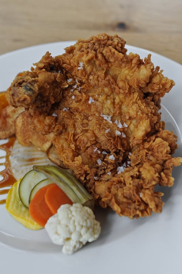 At White Oak Kitchen & Cocktails in Atlanta: caramel fried chicken, muddy rice, black pepper pan gravy, fleur de sel potato chips. BECKY STEIN/special