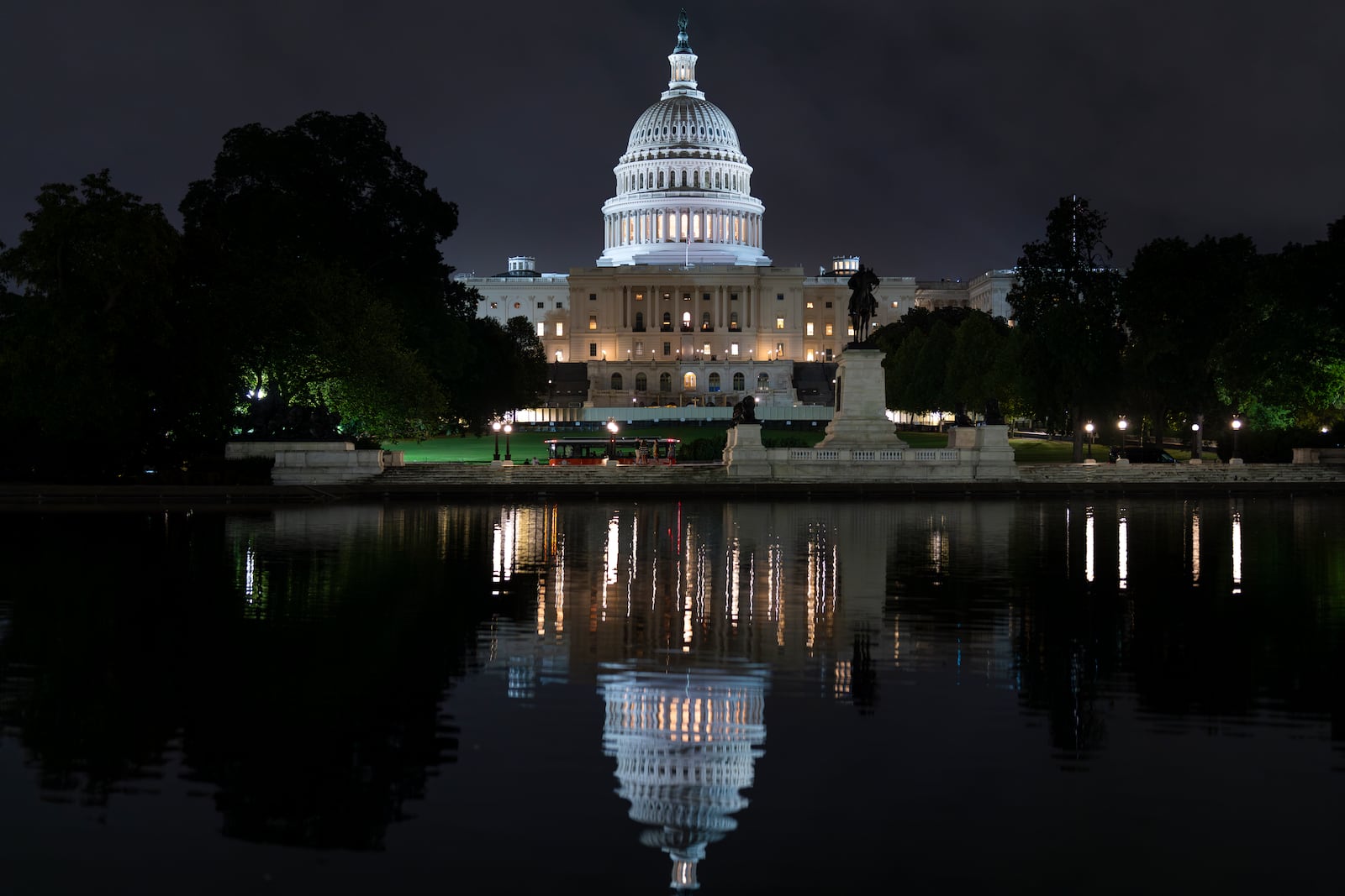 FILE - The Capitol is seen in the reflecting pool as lawmakers work into the evening, in Washington, Monday, Sept. 23, 2024. (AP Photo/J. Scott Applewhite, File)