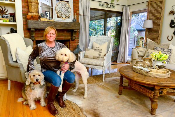 Sandra Boylan sits with her two dogs, Buddy and April, in her Atlanta living room. Boylan, an interior designer who has a booth at Queen of Hearts in Alpharetta, purchased the townhome in 2015 and has decorated with a combination of farmhouse, French and cottage style.