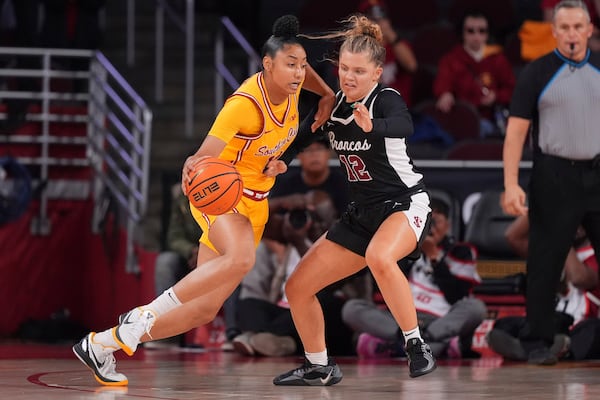 Southern California guard JuJu Watkins, left, drives against Santa Clara guard Maddie Naro during the first half of an NCAA college basketball game, Friday, Nov. 15, 2024, in Los Angeles. (AP Photo/Mark J. Terrill)