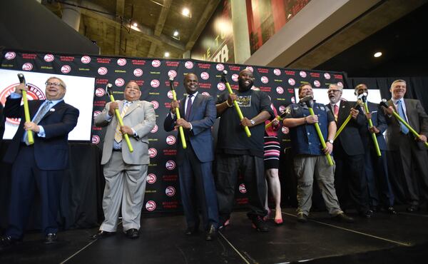  Killer Mike (center right) and Chef Rusty Hamlin (fourth from left) pose with sledgehammerrs at the announcement of the Philips Arena renovations. HYOSUB SHIN / HSHIN@AJC.COM