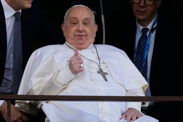 Pope Francis thumbs up as he appears at a window of the Agostino Gemelli Polyclinic in Rome, Sunday, March 23, 2025, where he has been treated for bronchitis and bilateral pneumonia since Feb. 14. (AP Photo/Domenico Stinellis)