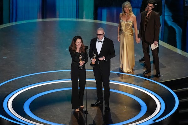 Shirin Sohani, left, and Hossein Molayemi accept the award for best animated short for "In the Shadow of the Cypress" during the Oscars on Sunday, March 2, 2025, at the Dolby Theatre in Los Angeles. Goldie Hawn, second right, and Andrew Garfield look on from right. (AP Photo/Chris Pizzello)