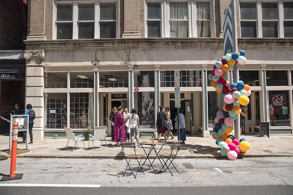 People gather along Mitchell Street during a “Pop-Up Row” shopping event in Atlanta’s south downtown community. (ALYSSA POINTER/ALYSSA.POINTER@AJC.COM)