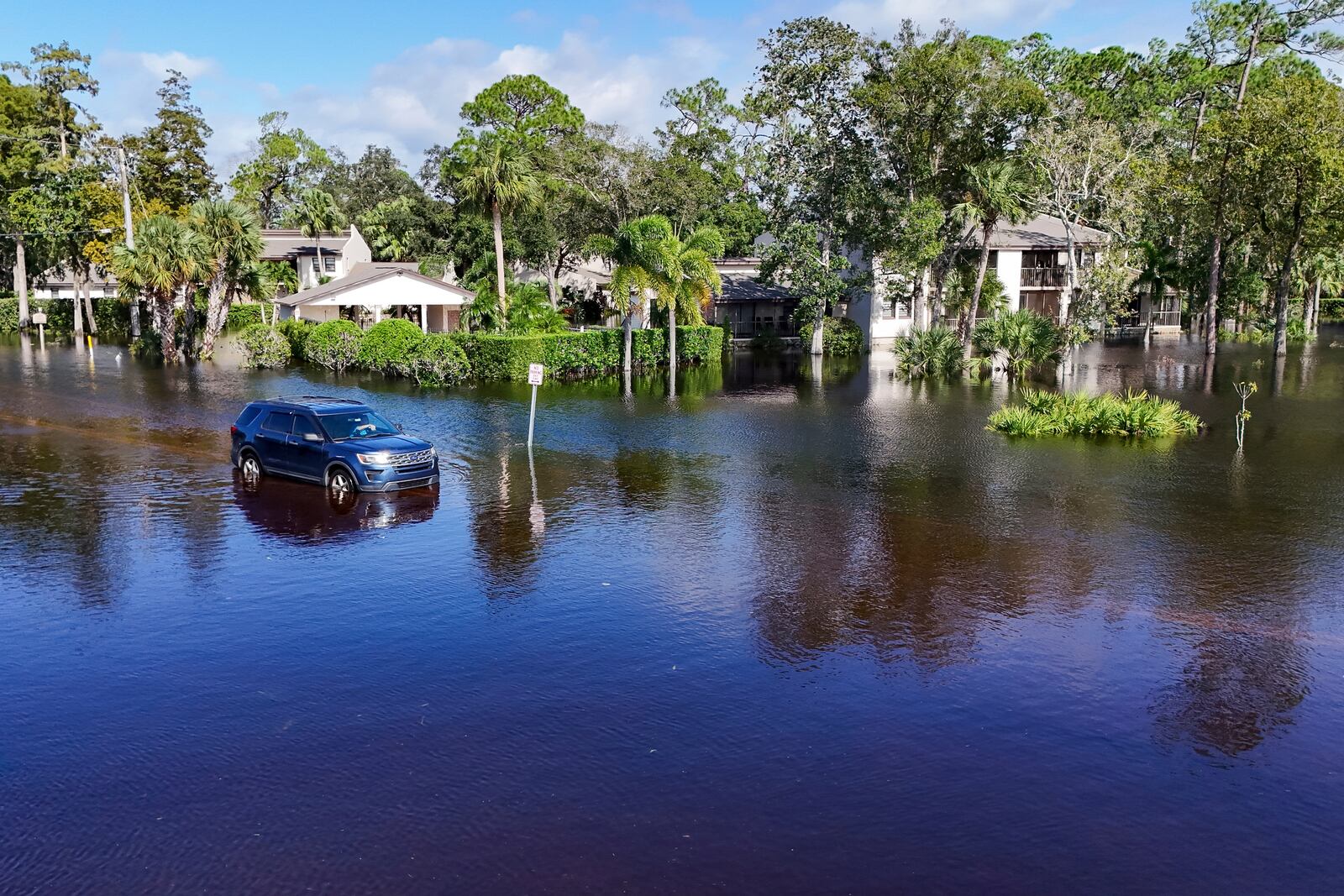 A motorist unsuccessfully tries to drive through flooding after Hurricane Milton, Thursday, Oct. 10, 2024, in Palm Harbor, Fla. (AP Photo/Mike Carlson)