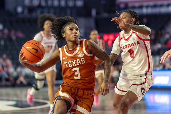 Texas guard Rori Harmon (3) drives the ball against Georgia guard Trinity Turner (0) during the first half of an NCAA college basketball game against Georgia, Monday, Feb. 24, 2025, in Athens, Ga. (AP Photo/Erik Rank)