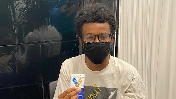 Georgia Tech student Grayson Prince holds a sticker given to him by a staff nurse after receiving his first COVID-19 vaccine shot on Tuesday, July 20, 2021. Georgia Tech has been conducting vaccinations on its campus each Tuesday. (Eric Stirgus / estirgus@ajc.com)