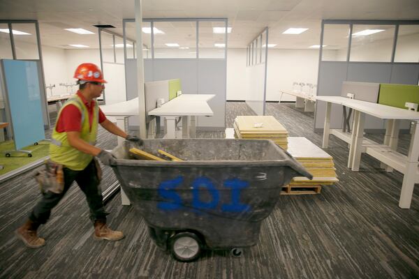 A construction worker New design of the work space at the Dell Round Rock Building 2 location on Friday, June 17, 2016.Several of Austin's major employers are embracing the work-from-home trend, in part because it saves them money, but also to attract Millennials. Among the leaders in telecommuting policies is Dell, which has an ambitious plan to have 50 percent of its workforce working from home by 2020. This also means changes in the way their office spaces look as fewer employees means fewer cubicle farms. We'll interview other major employers about how encouraging about their work from home policies.
RICARDO B. BRAZZIELL/AMERICAN-STATESMAN