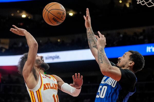 Atlanta Hawks guard Trae Young (11) shoots against Orlando Magic guard Cole Anthony (50) during the first half of an NBA basketball game, Thursday, Feb. 20, 2025, in Atlanta. (AP Photo/Mike Stewart)