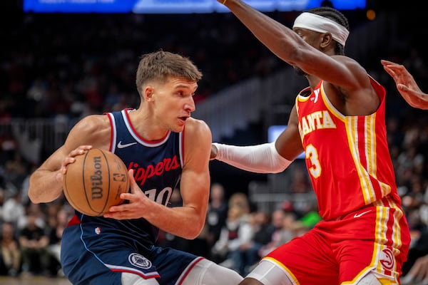 Los Angeles Clippers guard Bogdan Bogdanovic (10), left, moves the ball against Atlanta Hawks guard Caris LeVert (3), right, during the first half of an NBA basketball game, Friday, March 14, 2025, in Atlanta. (AP Photo/Erik Rank)