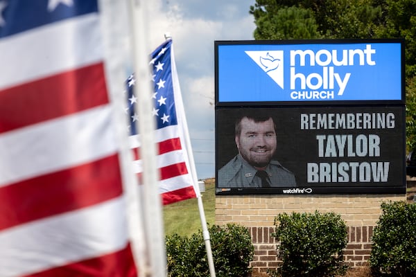 A sign at Mount Holly Church marks the funeral for Carroll County Investigator Taylor Bristow in Carrollton on Thursday. The deputy was shot while serving a warrant and died from his injuries. (Arvin Temkar / AJC)