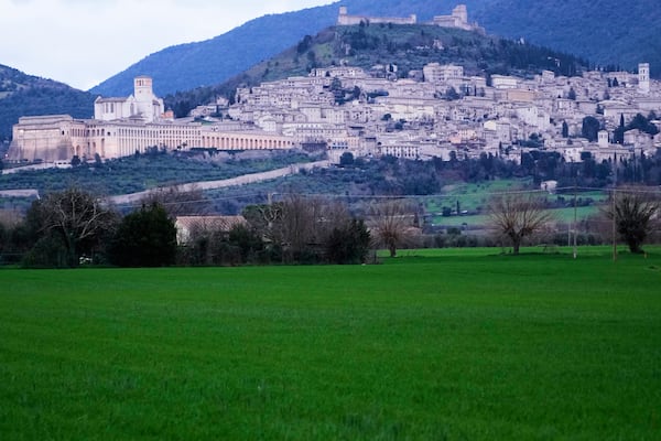 A view of Assisi in central Italy, with St. Francis Basilica, left, Saturday, March 1, 2025. (AP Photo/Gregorio Borgia)