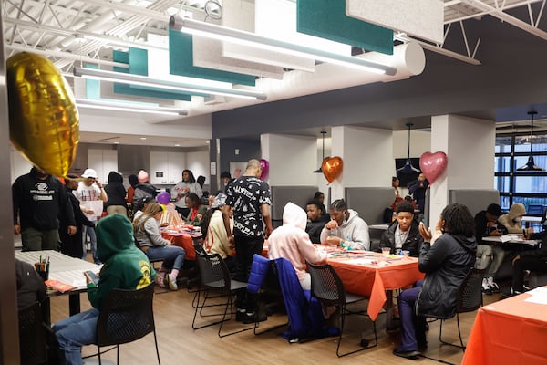 Students spend time in the common area inside of At-Promise Youth & Community Center South in Atlanta on Feb. 12. The center was created to give teens and young adults opportunities to get off the streets and explore other outlets and careers. Natrice Miller/AJC