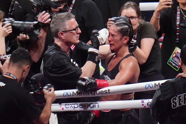 Amanda Serrano is attended to after fighting Katie Taylor in an undisputed super lightweight title bout, Friday, Nov. 15, 2024, in Arlington, Texas. (AP Photo/Julio Cortez)