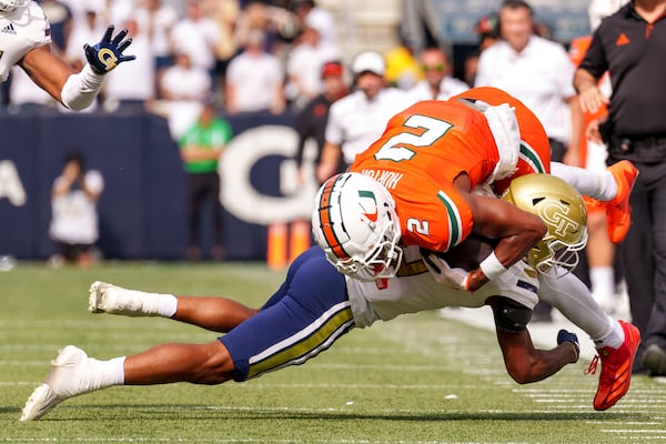 Miami wide receiver Isaiah Horton (2) is tackled out of bounds by Georgia Tech defensive back Ahmari Harvey, bottom, during the first half of an NCAA college football game, Saturday, Nov. 9, 2024, in Atlanta. (AP Photo/Jason Allen)