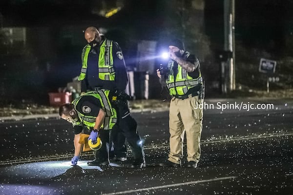 Decatur police officers collect evidence along Scott Boulevard where shots were fired in a road-rage incident early Monday morning.