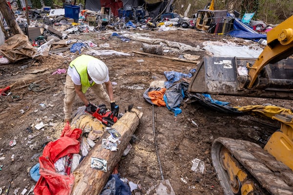 Santiago Murat helps to clear homeless encampments in Atlanta on Tuesday, February 27, 2024.  (Steve Schaefer/steve.schaefer@ajc.com)