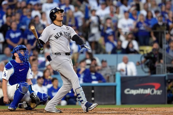 New York Yankees' Juan Soto, right, watches his home run along with Los Angeles Dodgers catcher Will Smith during the third inning in Game 2 of the baseball World Series, Saturday, Oct. 26, 2024, in Los Angeles. (AP Photo/Godofredo A. Vásquez)