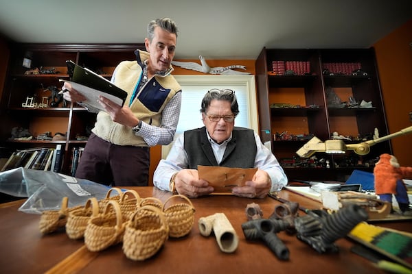 Appraiser Kaja Veilleux, seated, examines a document while associate appraiser Darrin Guitreau takes notes at Thomaston Place Auction Galleries, Tuesday, Nov. 19, 2024, in Thomaston, Maine. (AP Photo/Robert F. Bukaty)