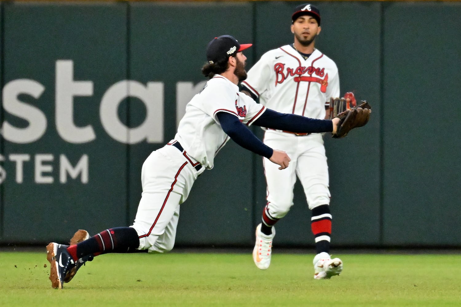 Atlanta Braves shortstop Dansby Swanson (7) makes an over the shoulder catch of the popup by Philadelphia Phillies’ J.T. Realmuto during the sixth inning of game two of the National League Division Series at Truist Park in Atlanta on Wednesday, October 12, 2022. (Hyosub Shin / Hyosub.Shin@ajc.com)