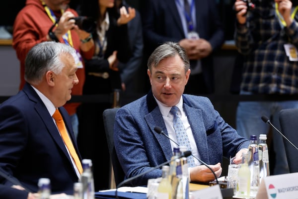 Hungary's Prime Minister Viktor Orban, left, speaks with Belgium's Prime Minister Bart De Wever during a round table meeting at an EU Summit in Brussels, Thursday, March 6, 2025. (AP Photo/Geert Vanden Wijngaert)