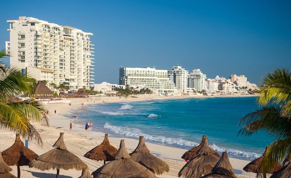 Resort hotels line the beach in Cancun, Mexico. A spring break trip might feel like the perfect solution to being tired of winter, but then comes the onerous task of vacation planning. (Brad Calkins/Dreamstime/TNS)