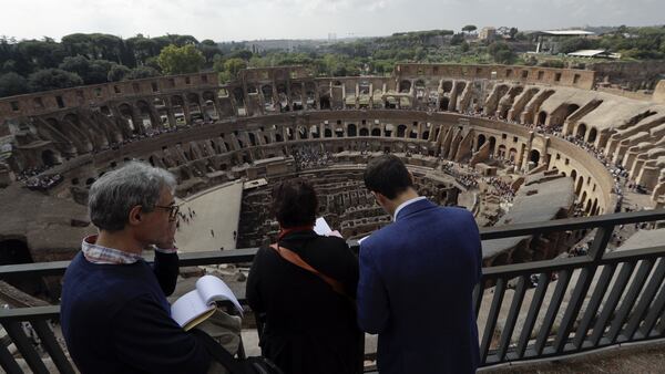 Journalists looks out from topmost level of the ancient Colosseum on the occasion of a media tour presenting the re-opening after forty years of the fourth and fifth level of the Italy's most famous site, in Rome, Tuesday, Oct. 3, 2017. Italian Culture Minister Dario Francheschini was on hand Tuesday to tour the new levels, which during ancient Roman times were the cheapest seats, reserved for the plebes because they were farther away from the spectacle and exposed to Rome's harsh sun.  (AP Photo/Andrew Medichini)