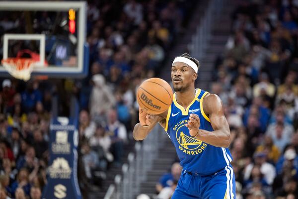 Golden State Warriors forward Jimmy Butler III passes the ball during the first half of an NBA basketball game against the Portland Trail Blazers in San Francisco, Monday, March 10, 2025. (AP Photo/Nic Coury)