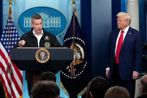 President Donald Trump listens as Transportation Secretary Sean Duffy speaks in the James Brady Press Briefing Room at the White House, Thursday, Jan. 30, 2025, in Washington. (AP Photo/Alex Brandon)