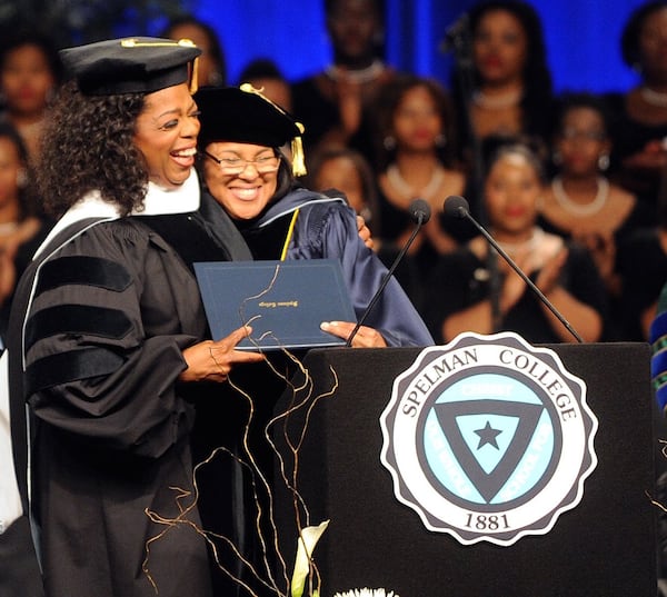 Oprah Winfrey hugs Rosalind D. Brewer, Spelman class of 1984, during Spelman's 2012 Commencement. AJC file photo/Bita Honarvar