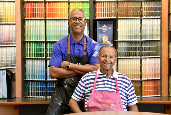 Father and son Thomas Portis and Thomas Portis Jr. pose for a photo at Southwest Paint and Decorating, Thursday, July 10, 2024 in Atlanta. The Southwest Paint and Decorating Center on Ralph David Abernathy Blvd. has remained open for five decades since Portis purchased the business. He and his family have kept it afloat through hardships over the years like the COVID-19 pandemic.(Hyosub Shin / AJC)