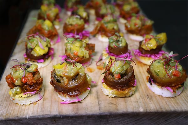 Pork skin braciola, grilled Vidalia grit crostini, peach confit by chef Deborah VanTrece is seen during a preview dinner at White Oak Kitchen & Cocktails in Atlanta for a June 7 Georgia Grown dinner at the James Beard House in New York City. CURTIS COMPTON / CCOMPTON@AJC.COM