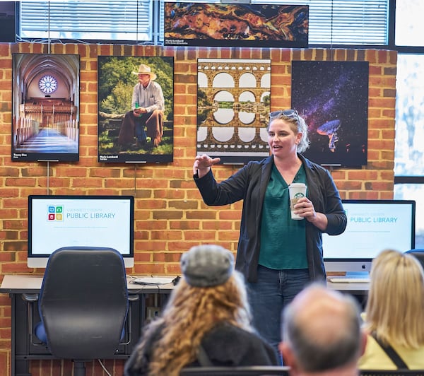 At the Peachtree Corners Photography Club exhibit grand opening judge Amanda Graham explains how she selected the top photos. Photo courtesy of Brian Walton Photography