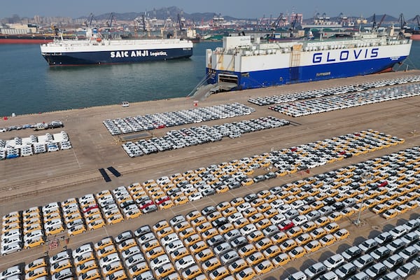 Vehicles and trucks for export wait for transportation from a port in Yantai in eastern China's Shandong province on Jan. 2, 2025. (Chinatopix via AP)