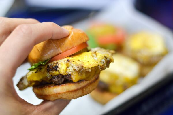 A fried egg and cheddar slider at Sliders Burger Joint in Forest Park. CONTRIBUTED BY HENRI HOLLIS