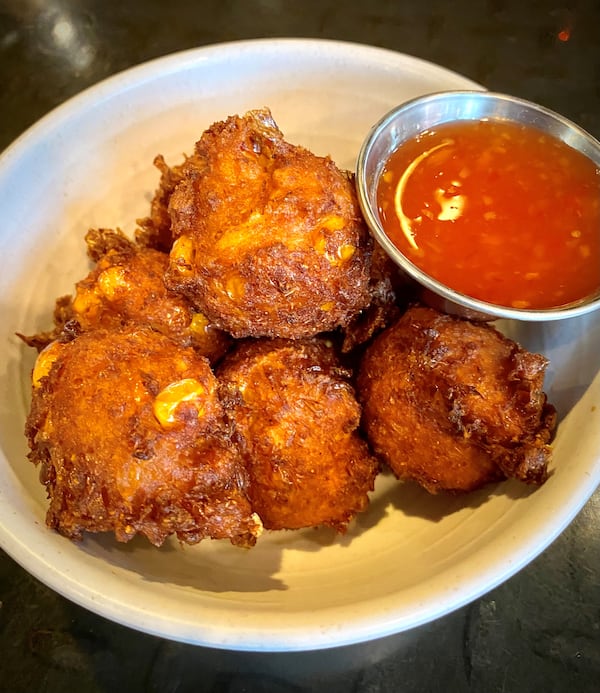 Jackalope’s corn fritters, made with red curry and lime leaf, and served with a sweet-chile dipping sauce, are one of the pop-up's more popular items. Wendell Brock for The Atlanta Journal-Constitution